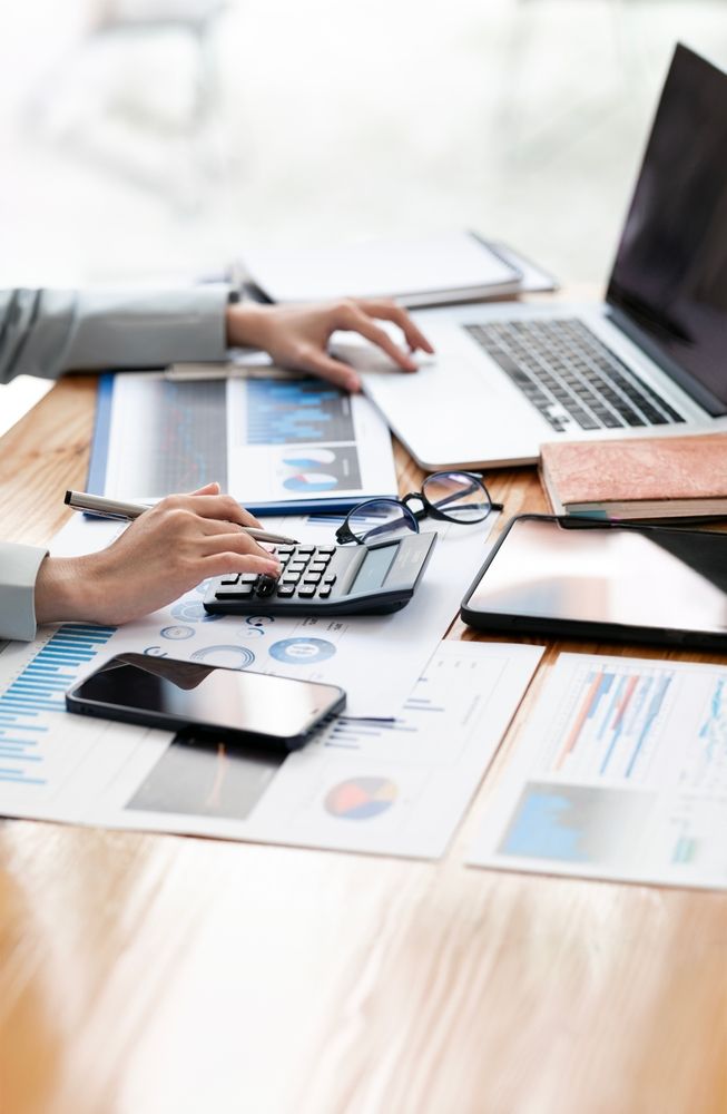 accountant uses calculator at computer