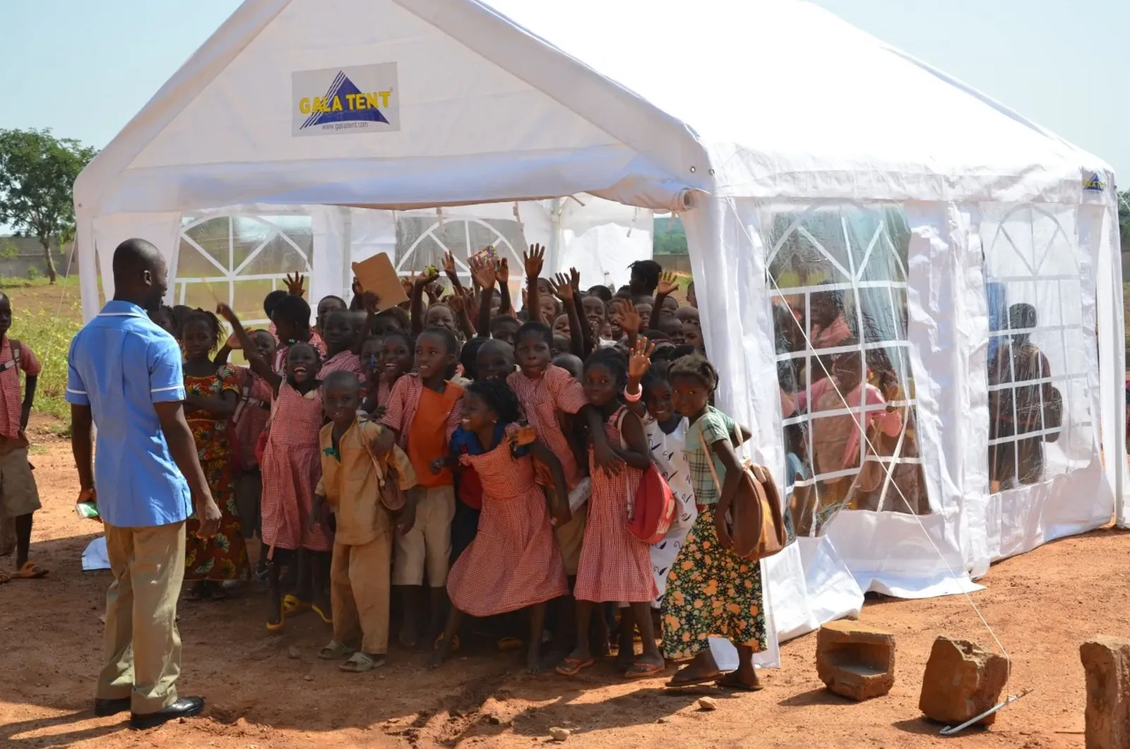 African children beneath a gala tent marquee