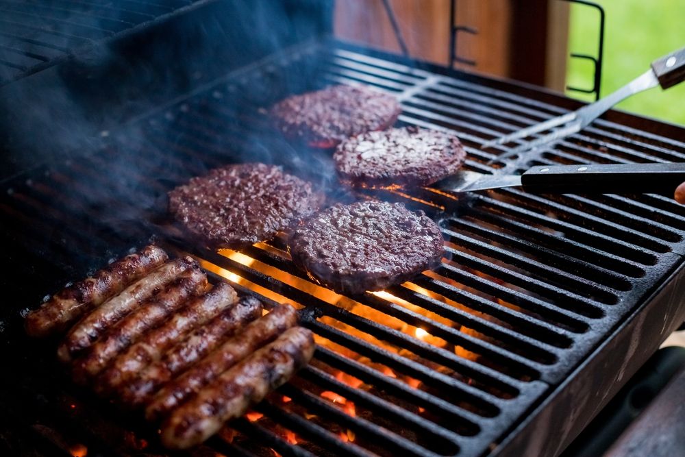 burgers and sausages on a barbecue
