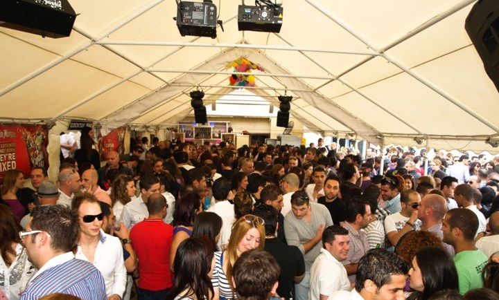 large marquee with hundreds of people standing inside it