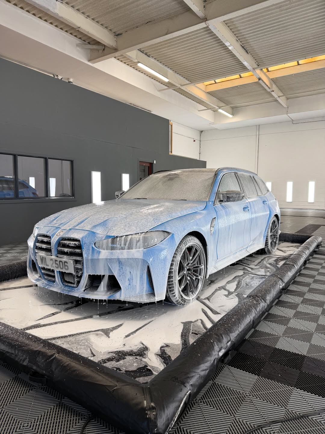 BMW being cleaned in swisstrax detailing bay