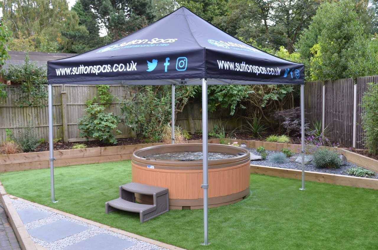 a branded pop up gazebo covers a hot tub