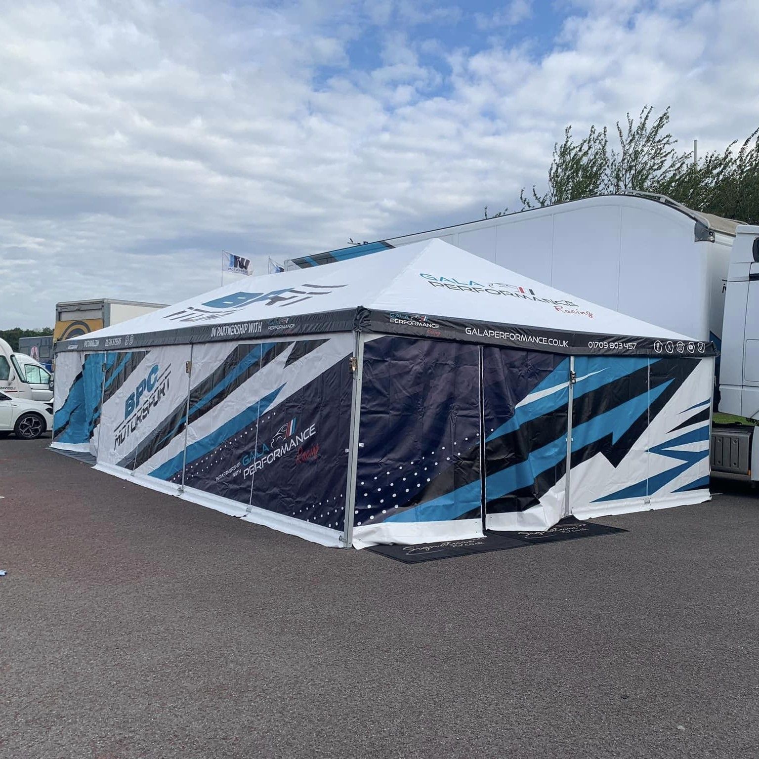 heavy duty motorsport tent with blue branding