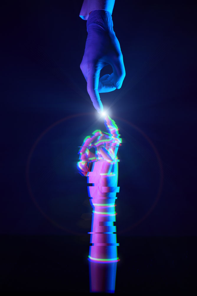 a human hand reaches toward a robotic AI arm