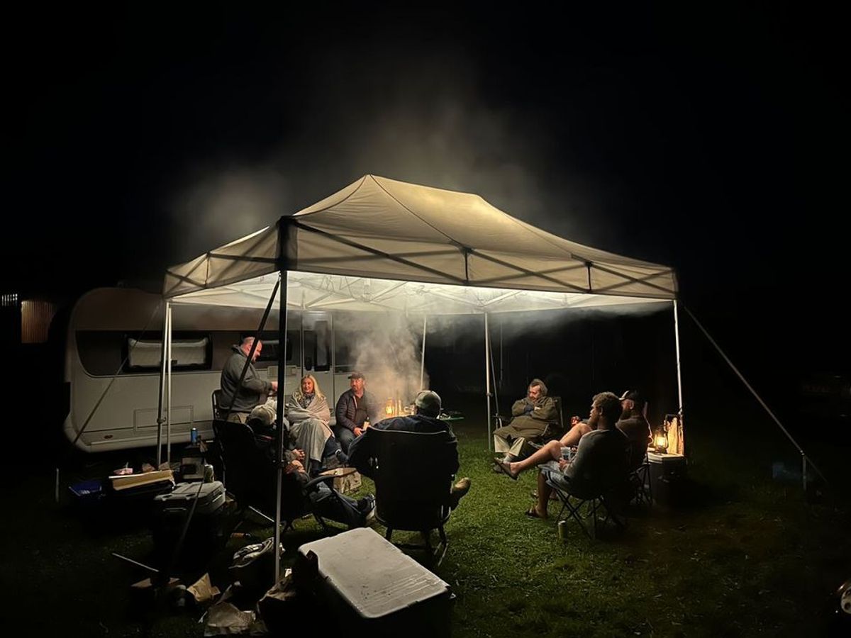 camping gazebos set up around a campfire