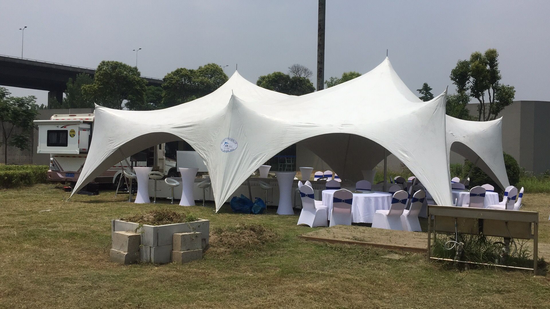 A white capri tent in a field