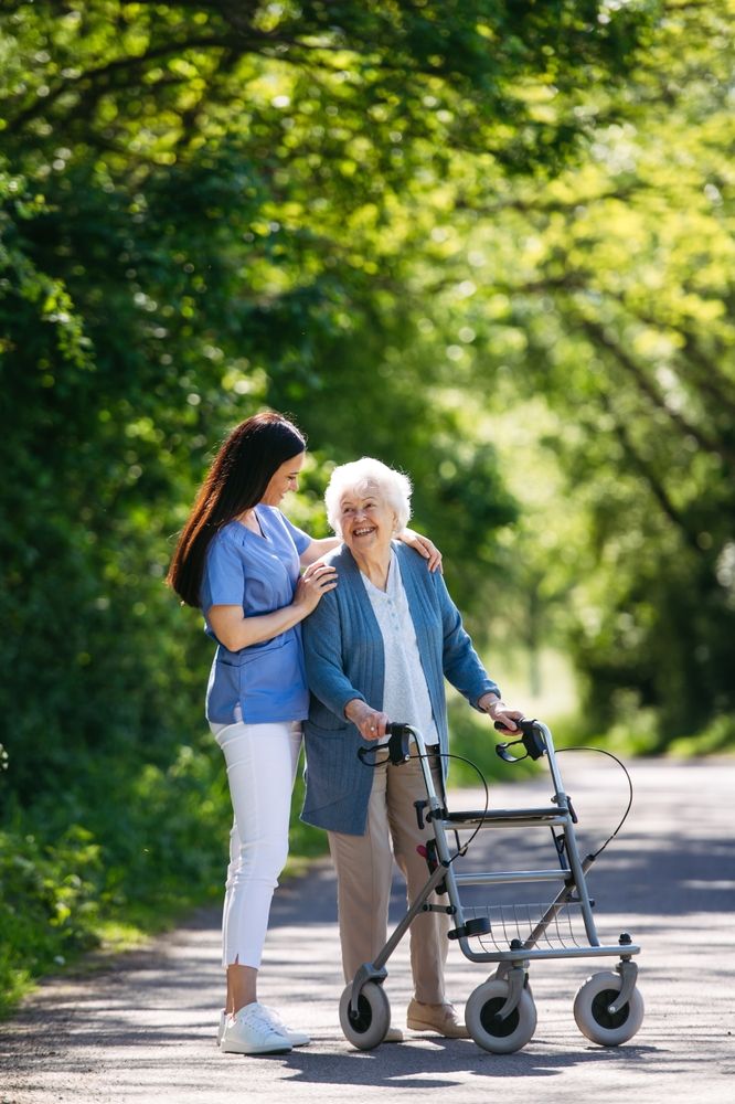 a carer looks after an elderly lady in a garden