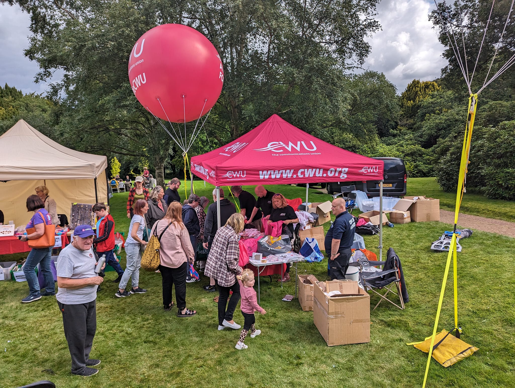 a not-for-profit organisation's red gazebo with people around it