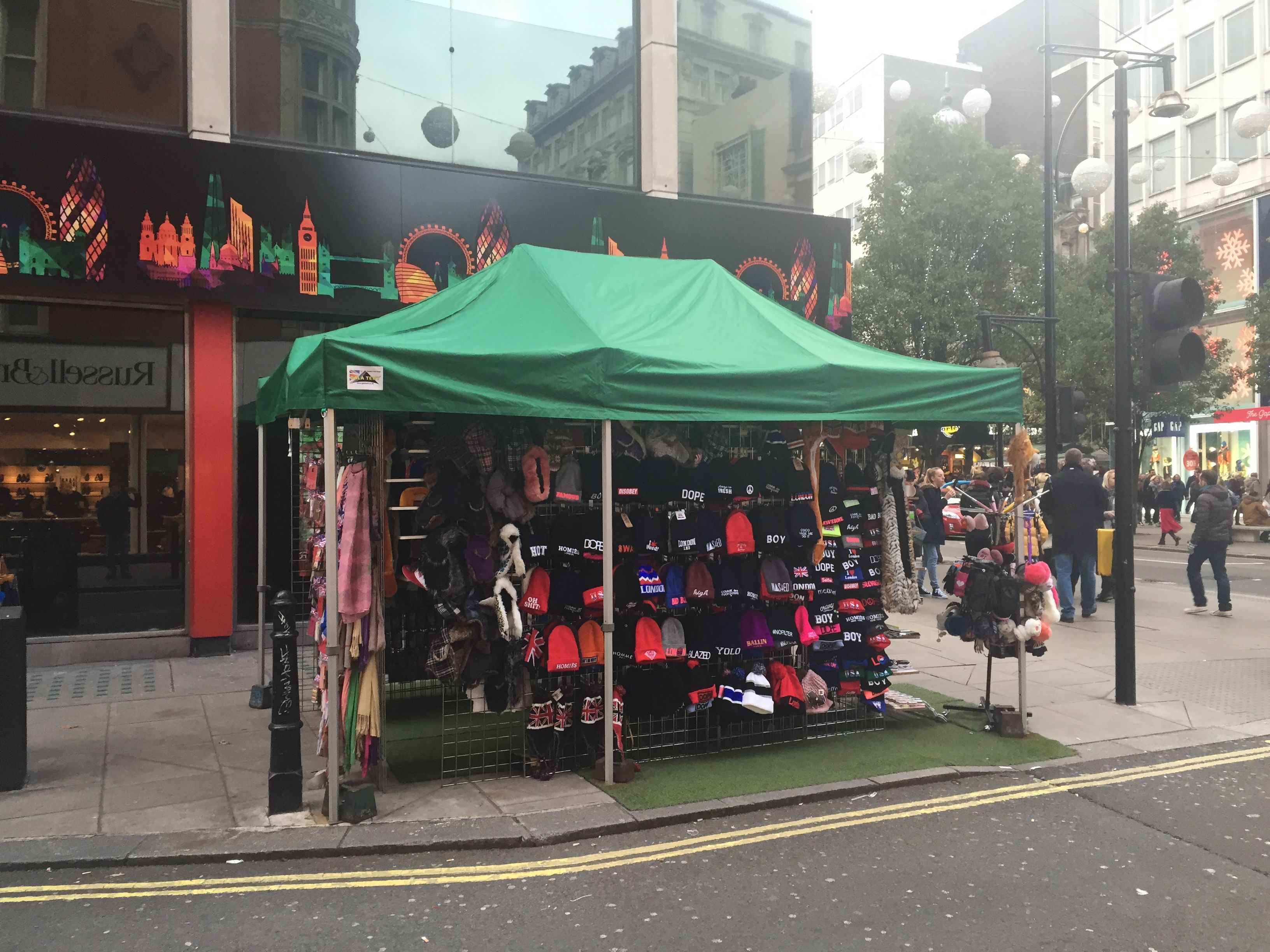 Custom made clothing being sold at a gazebo stand