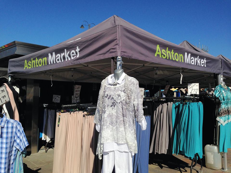 handmade clothing hanging from gazebo stand