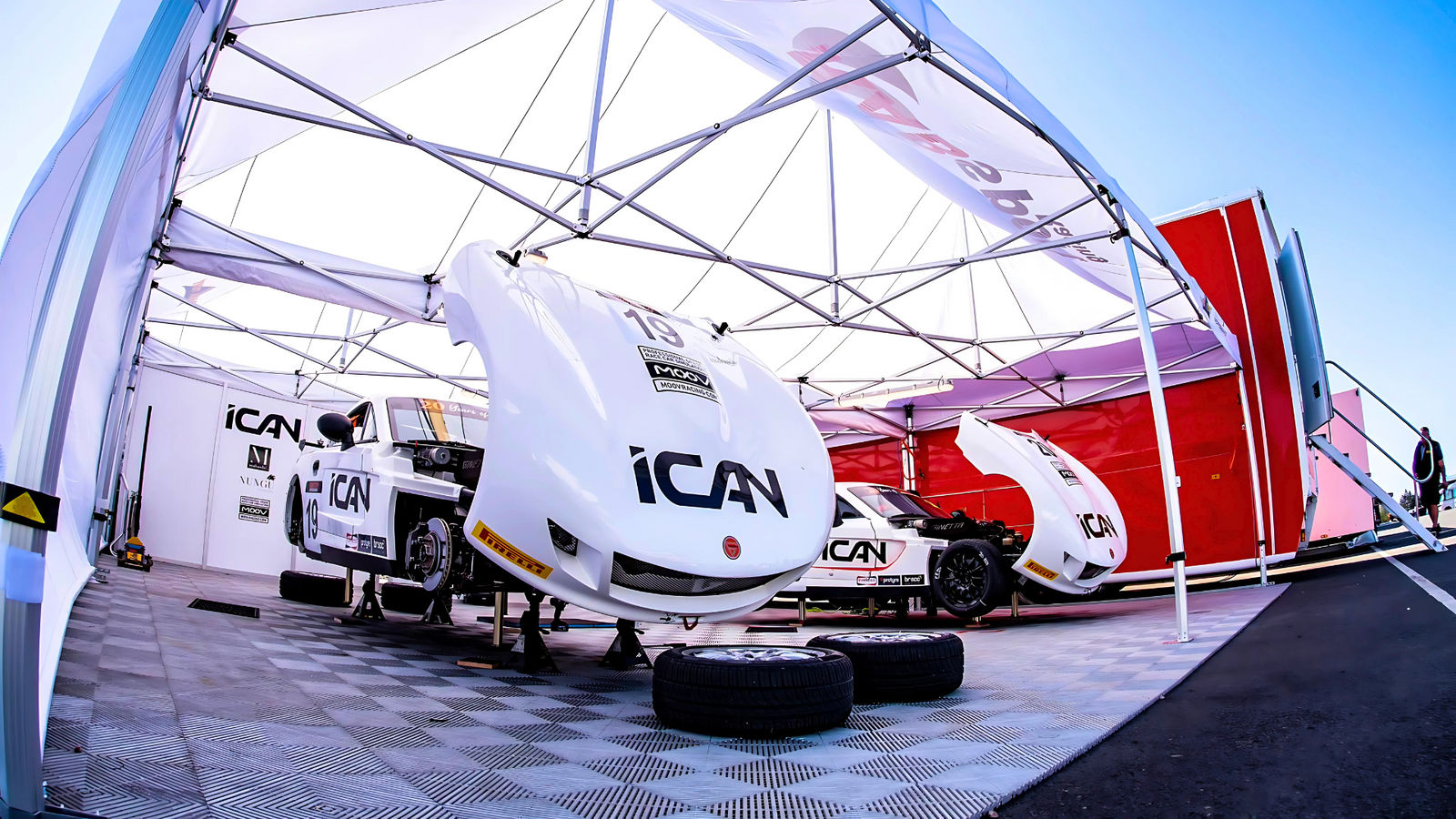 Car being repaired under branded gazebo