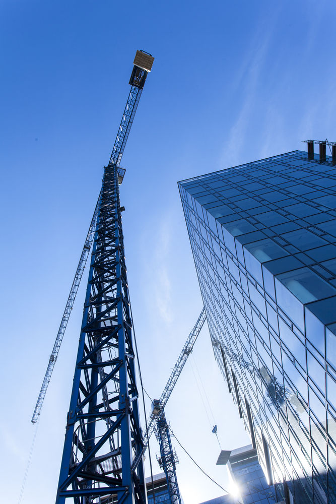 a crane working on a skyscraper