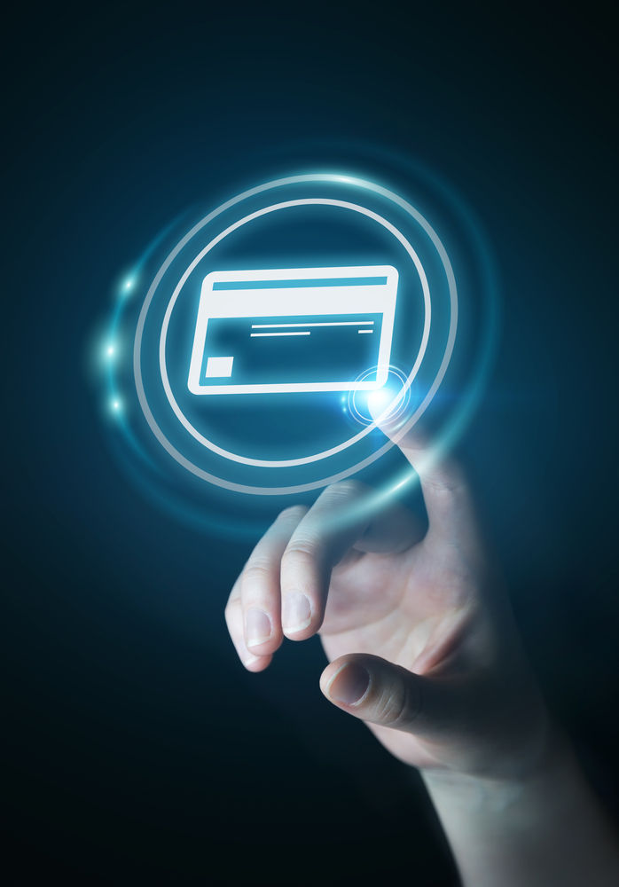 A finger presses an illuminated payment card icon