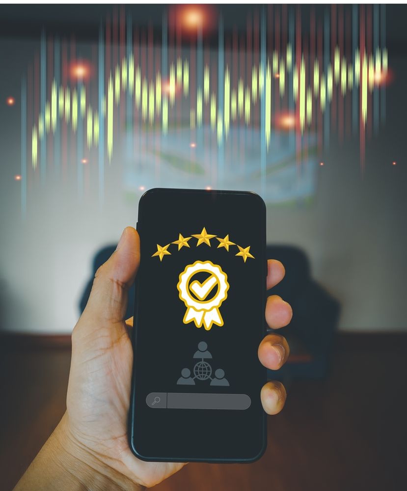 smartphone held in a hand, with 5 stars and a tick on the interface
