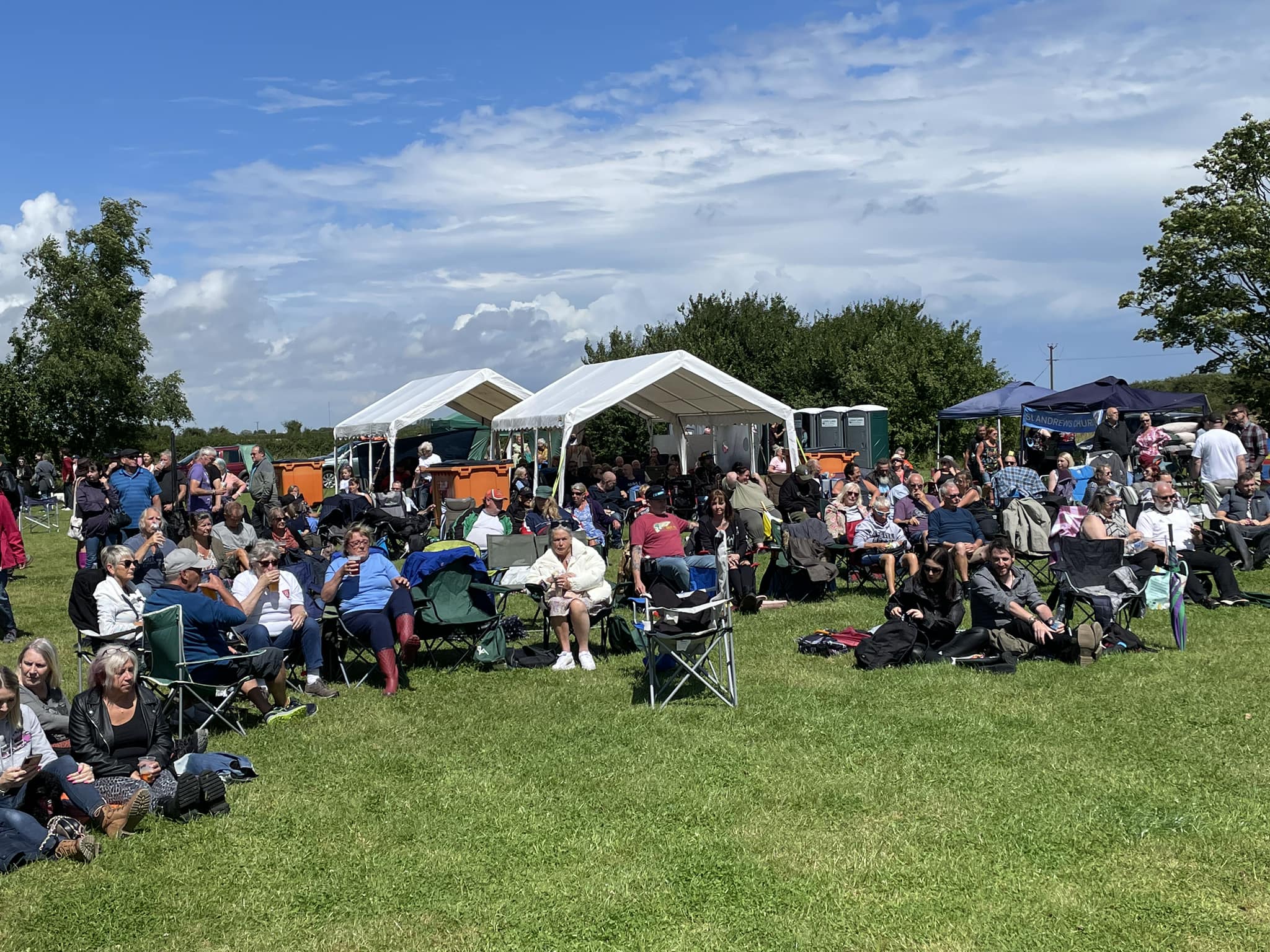 marquees in a field at a community fair
