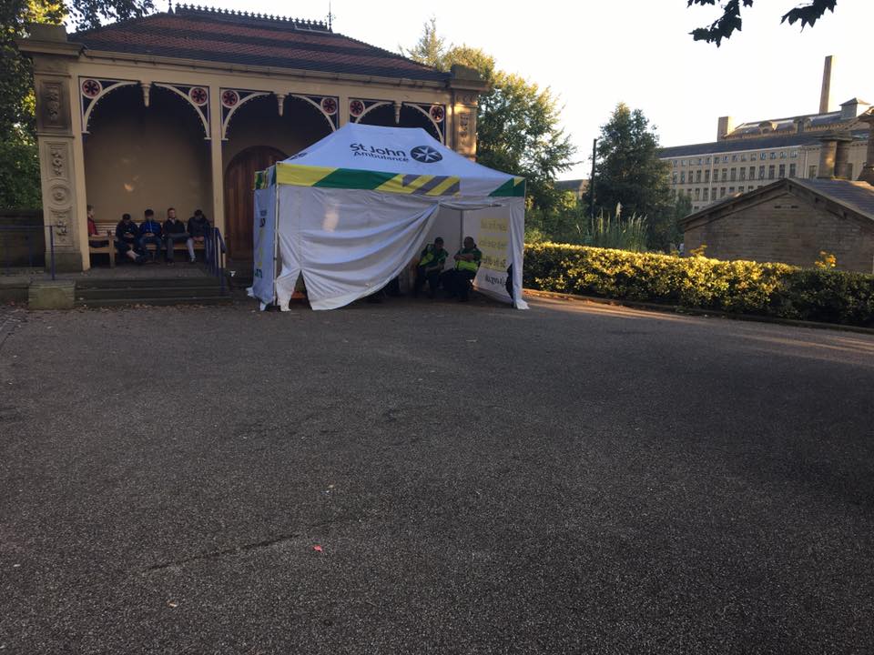 A white pop up first aid tent in a courtyard