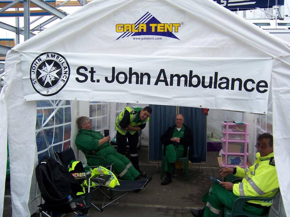 A white pop up first aid tent in a courtyard