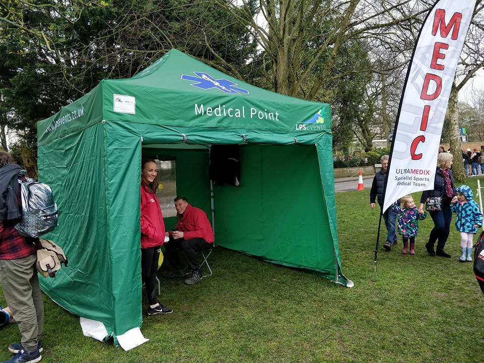 medical team under a green gazebo at an event