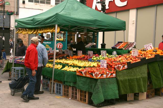 Shoppers at a fresh fruit and vegetable stand