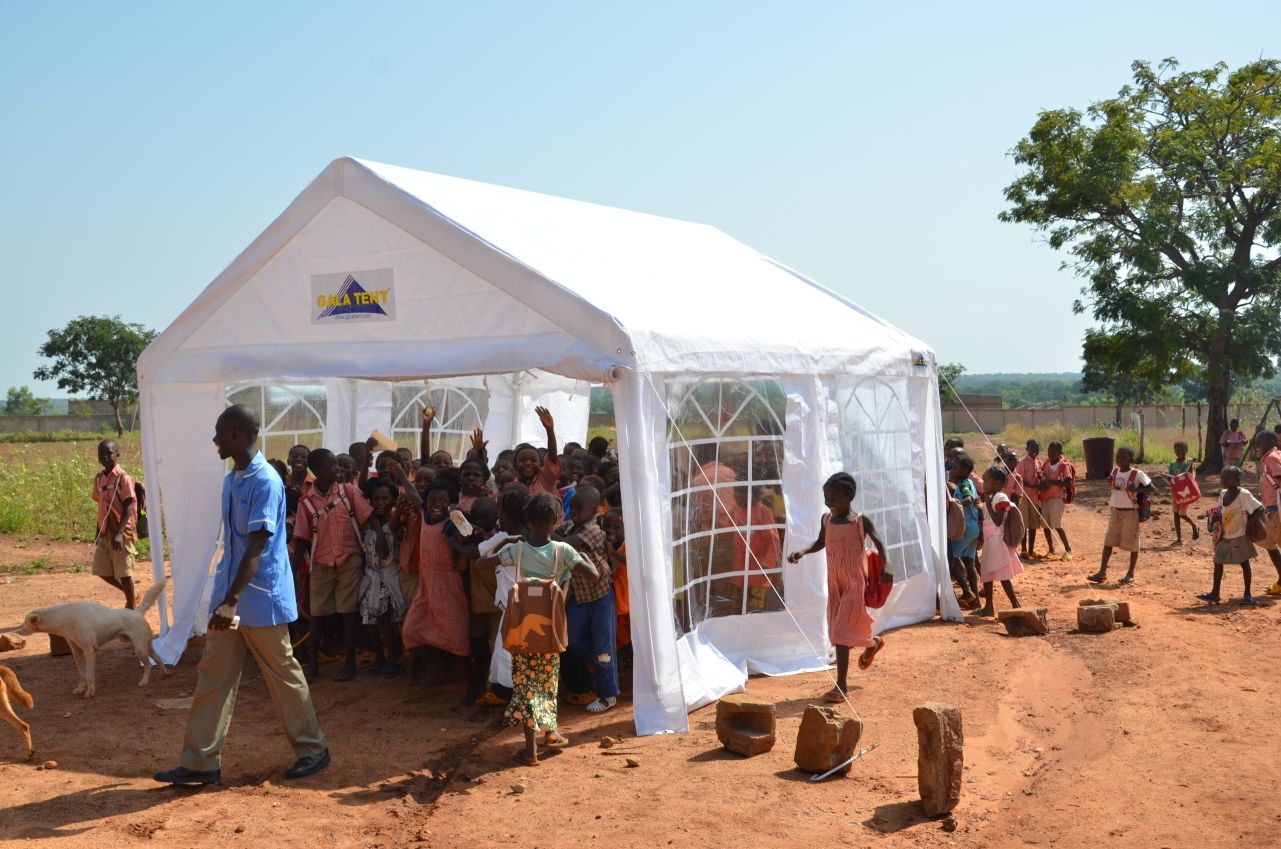gala tent marquee in african village with children beneath it