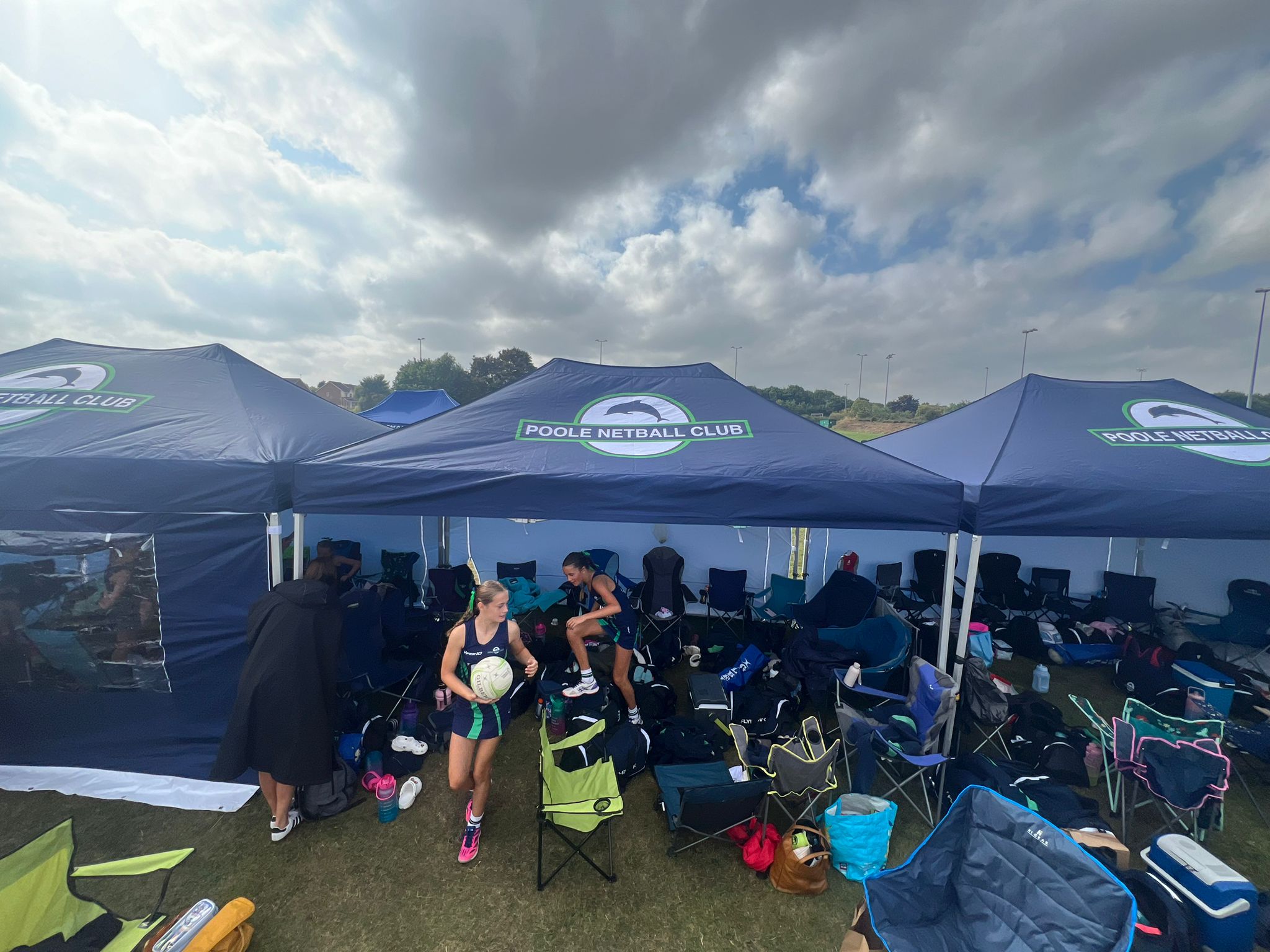 branded gazebos cover a changing area for a netball team