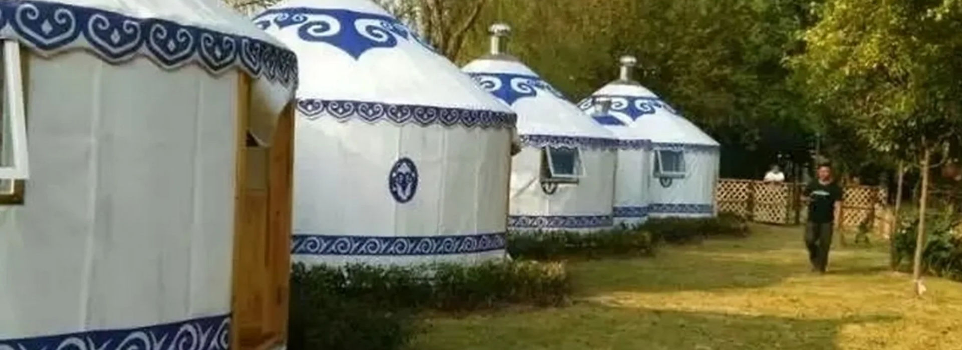 blue and white yurts in holiday park