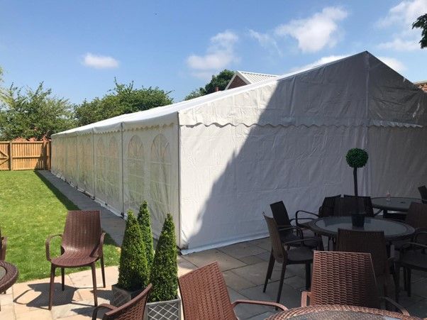 Elegant white wedding marquee venue setup