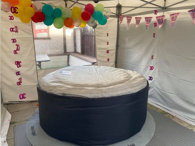 a covered hot tub beneath a gazebo