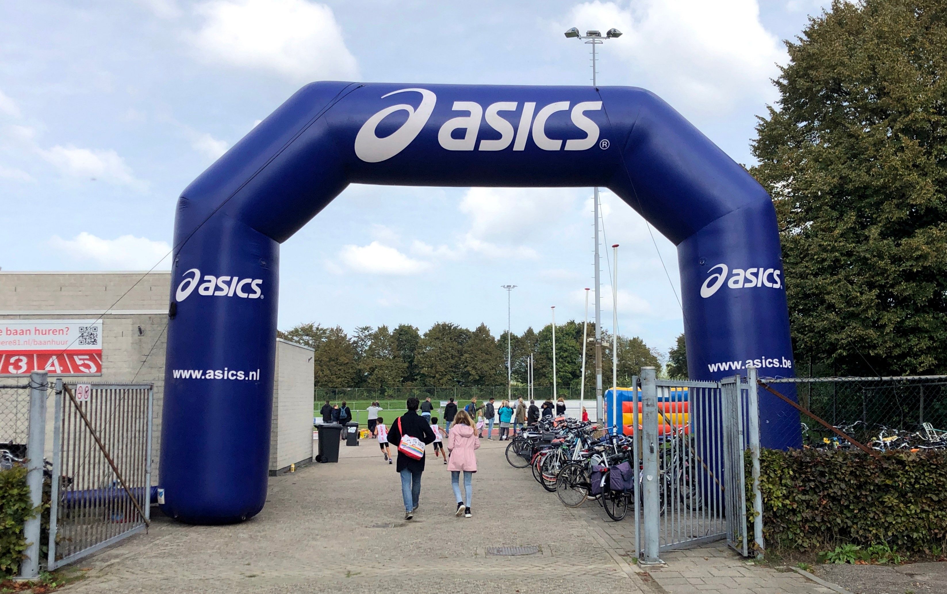 large blue inflatable arch with Asics branding