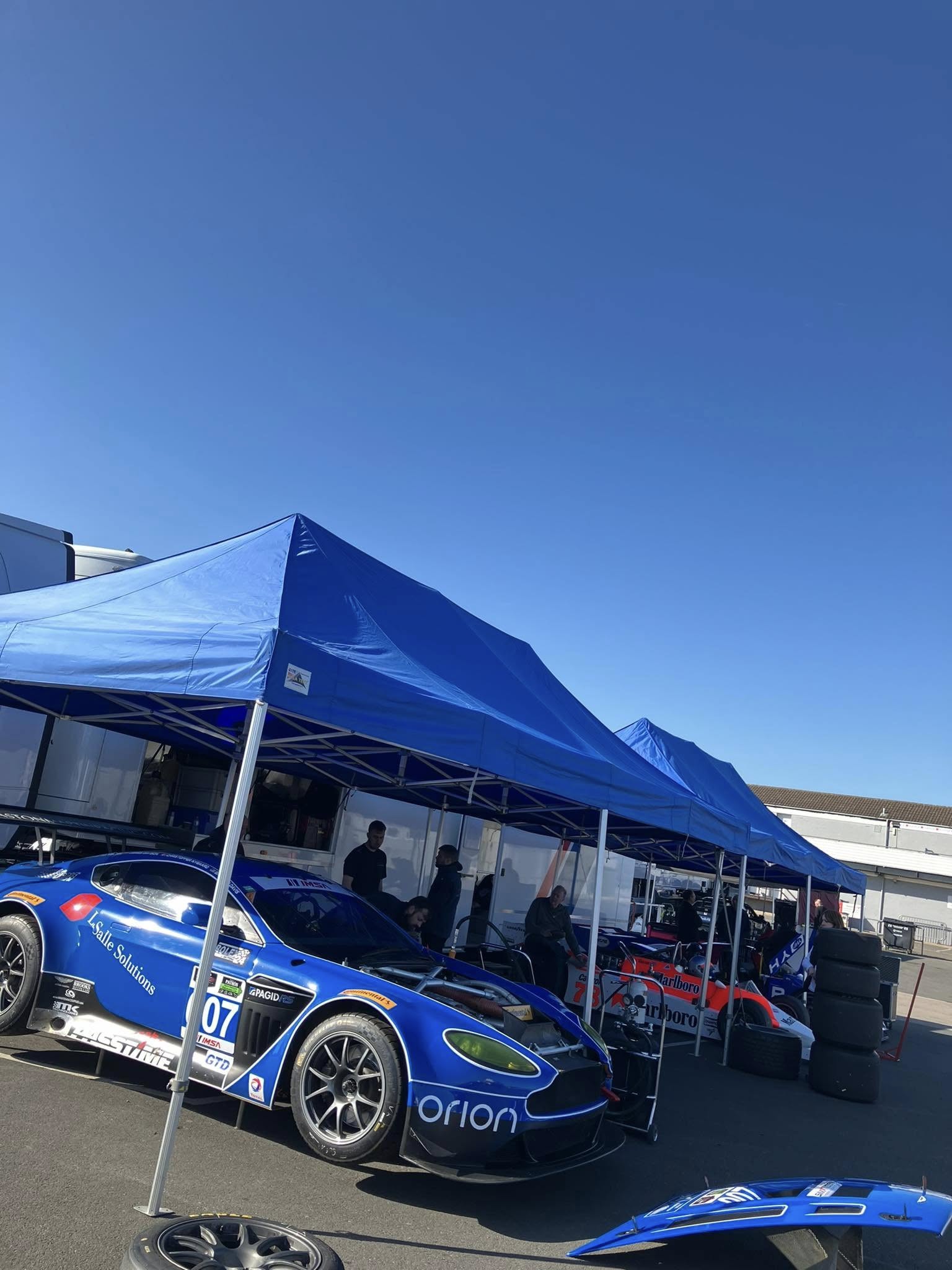 racing cars beneath an instant motorsport gazebo
