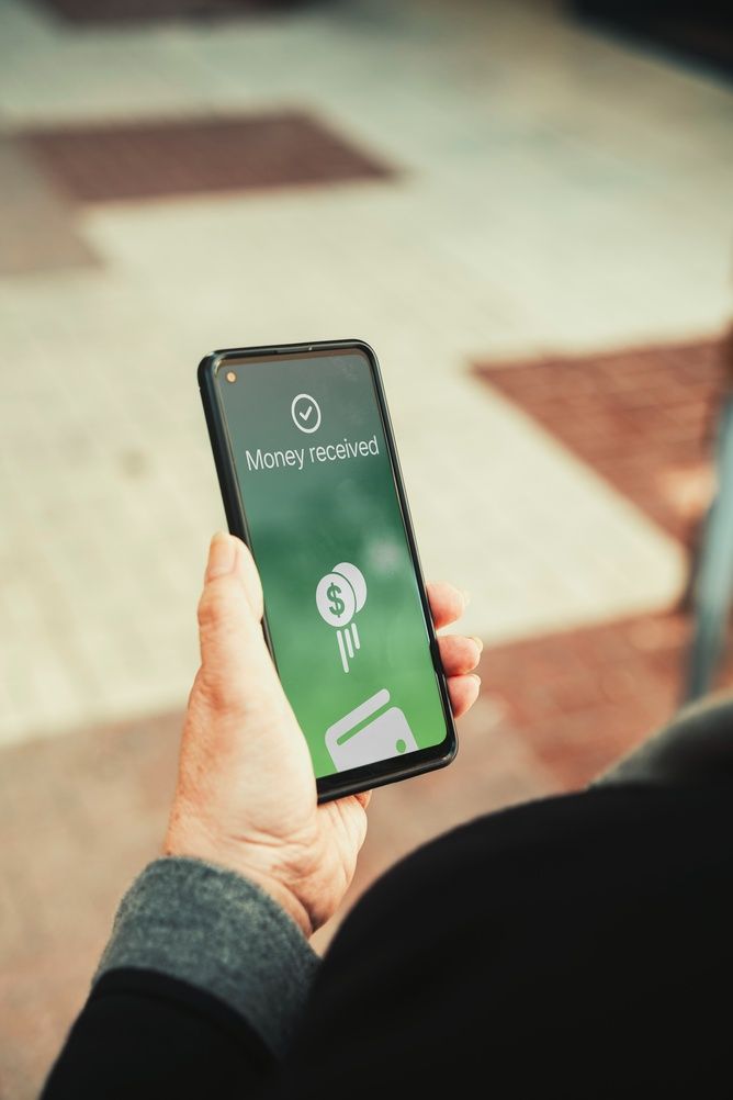 a smartphone screen with the words "Money received"