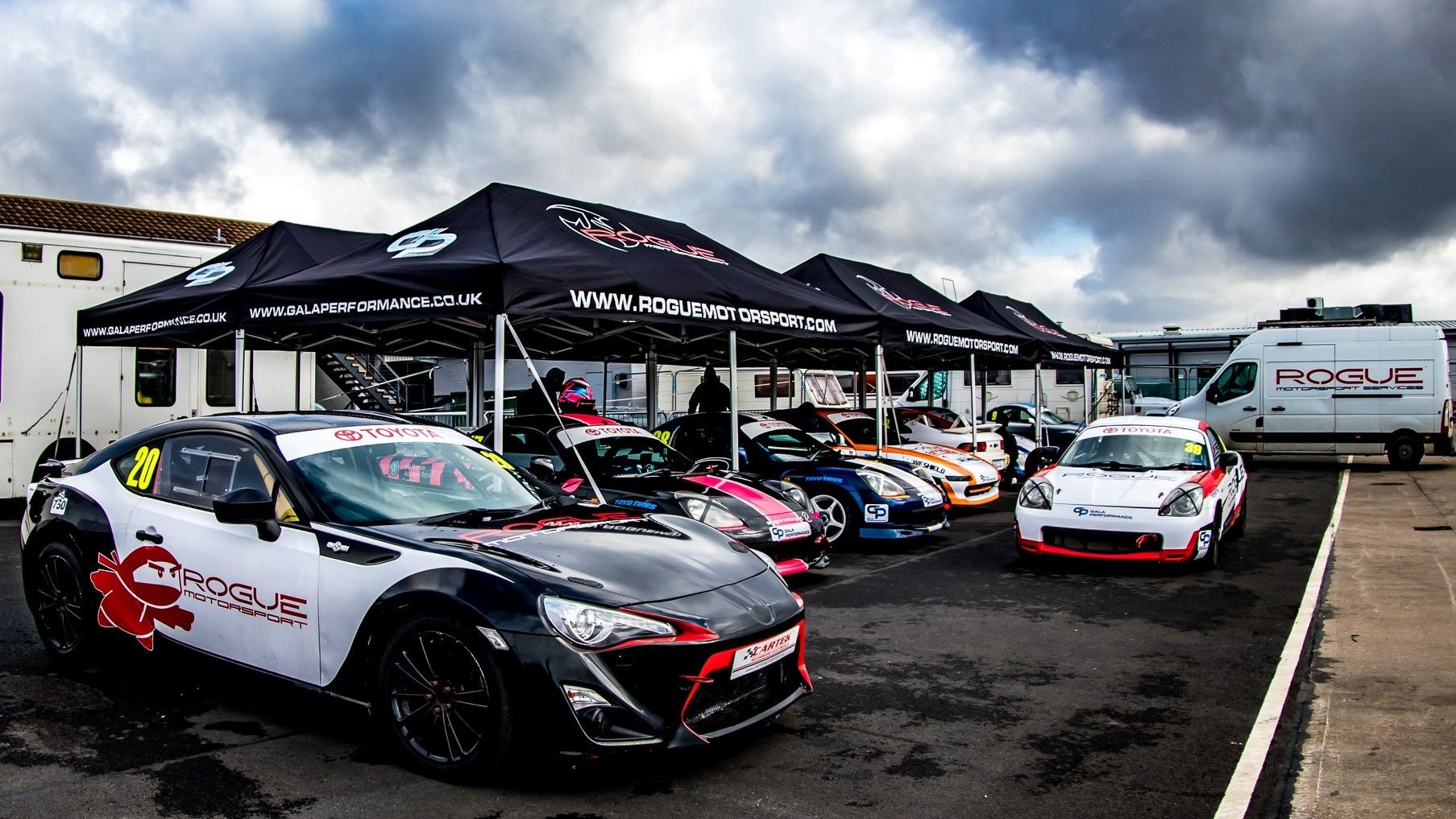 printed black gazebos in a motorsport paddock