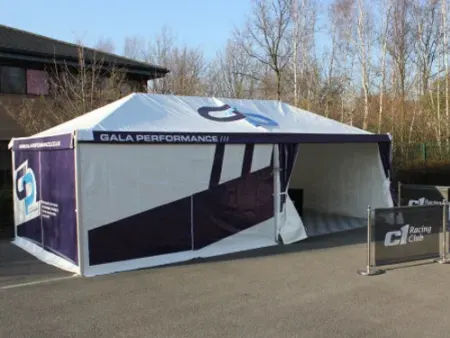 branded blue and white marquee in a courtyard