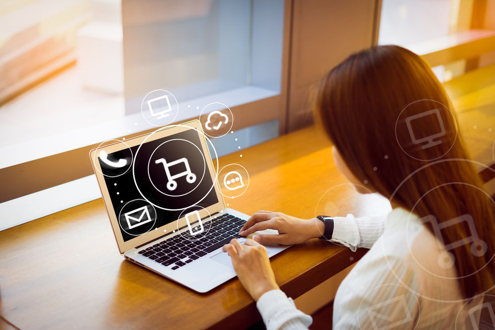 a woman on a laptop computer, with an overlay to denote online shopping