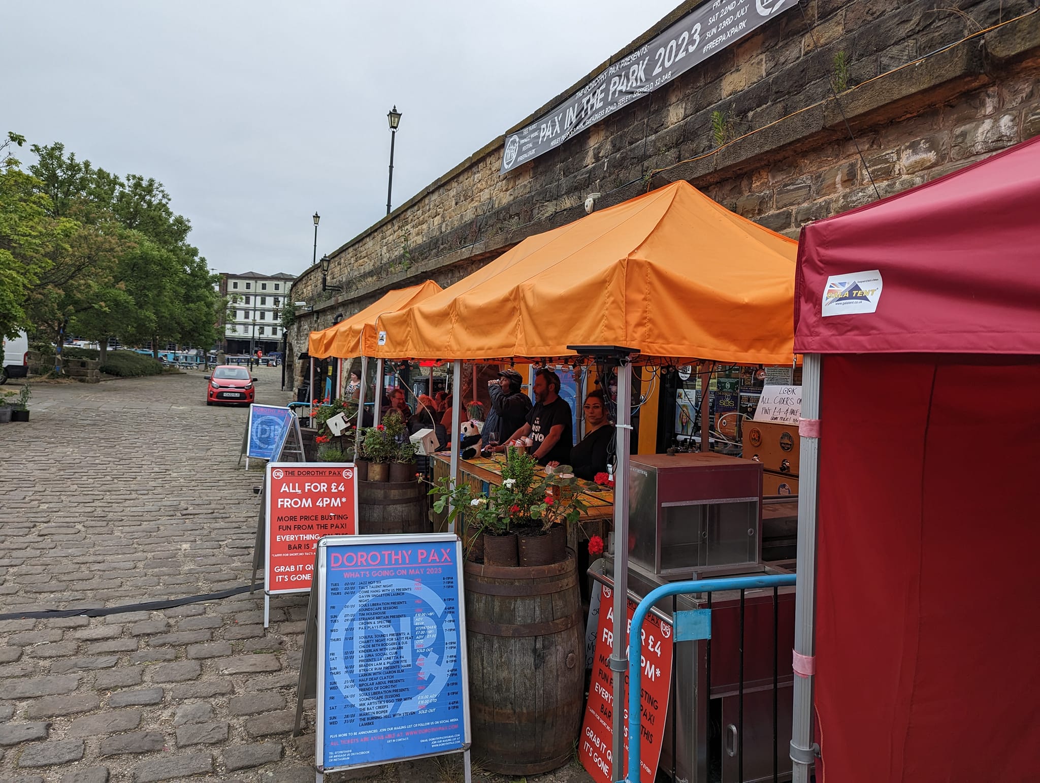 orange and red metal gazebos outside a pub