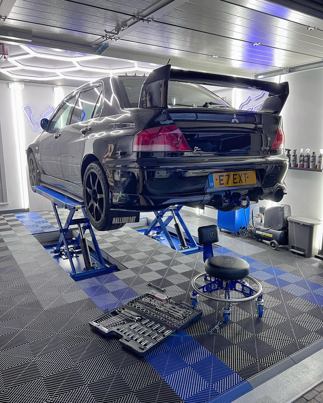 Evo being worked on in home garage with swisstrax installed