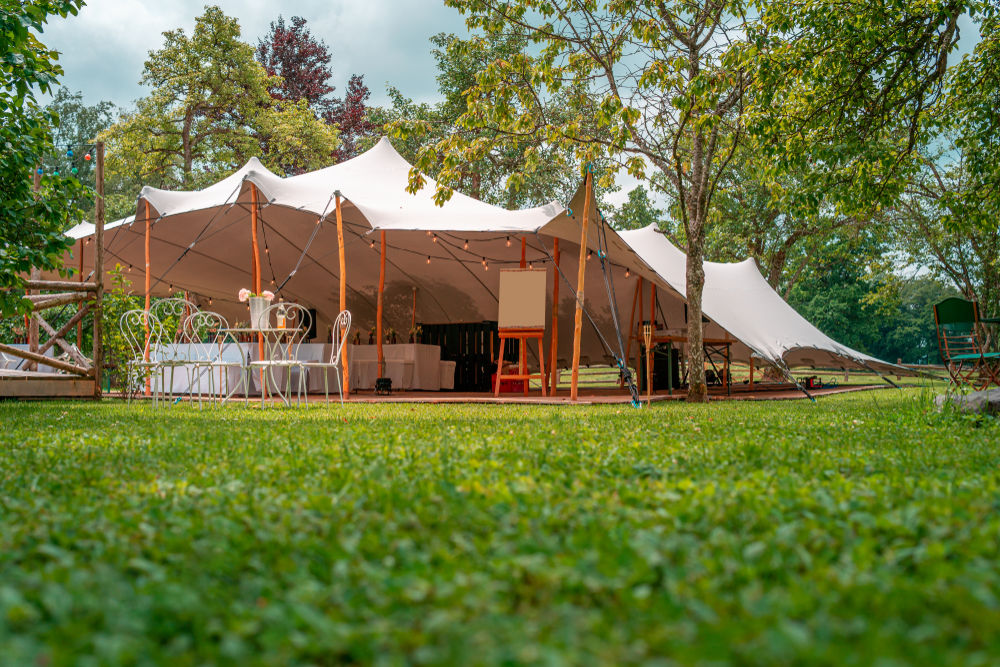 a large marquee beside a red gazebo
