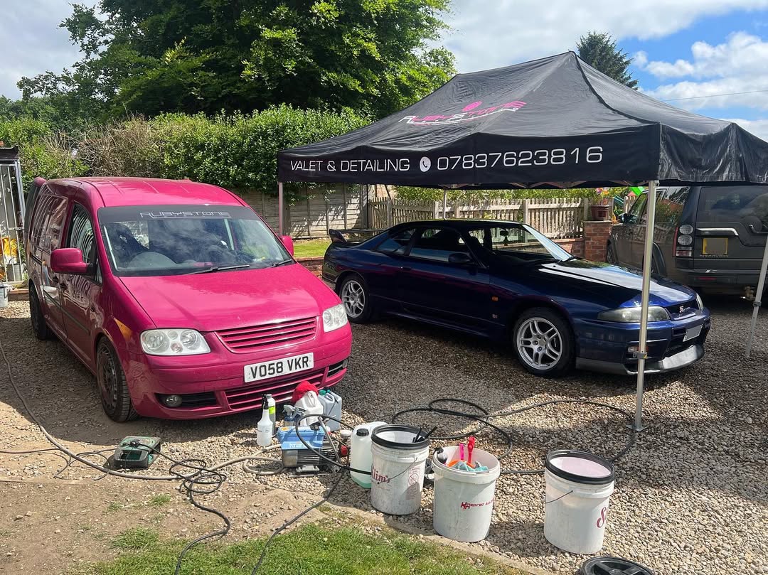 a black gazebo over a car for valeting