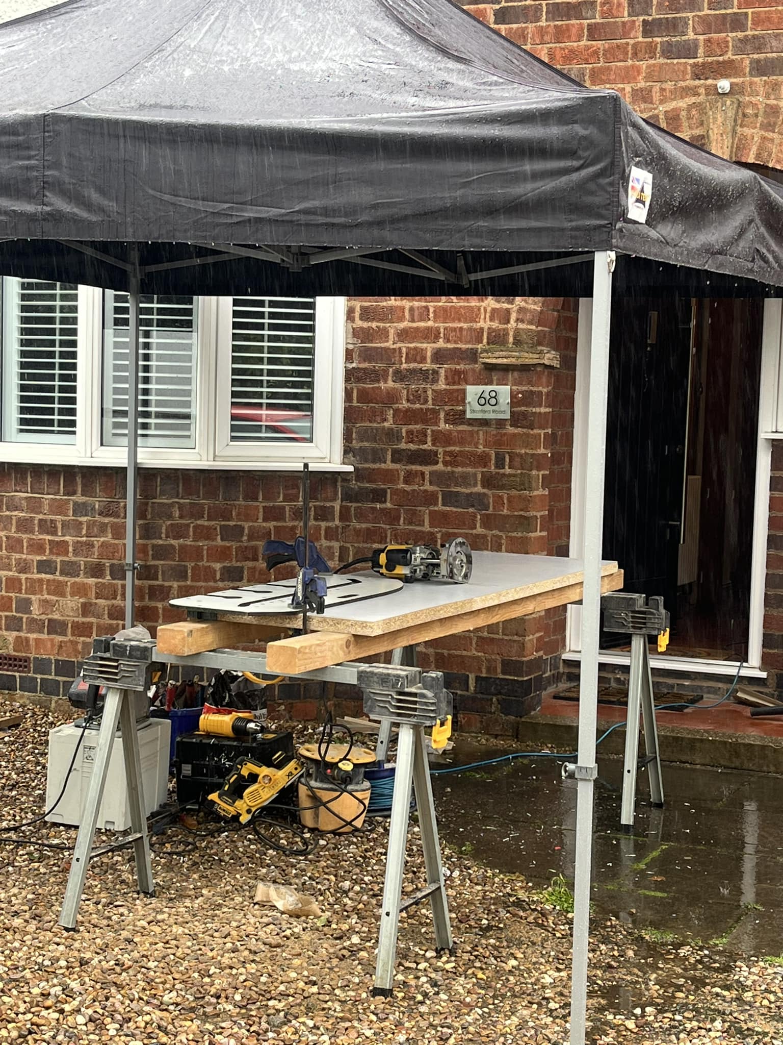 waterproof construction shelter gazebo with tools beneath it