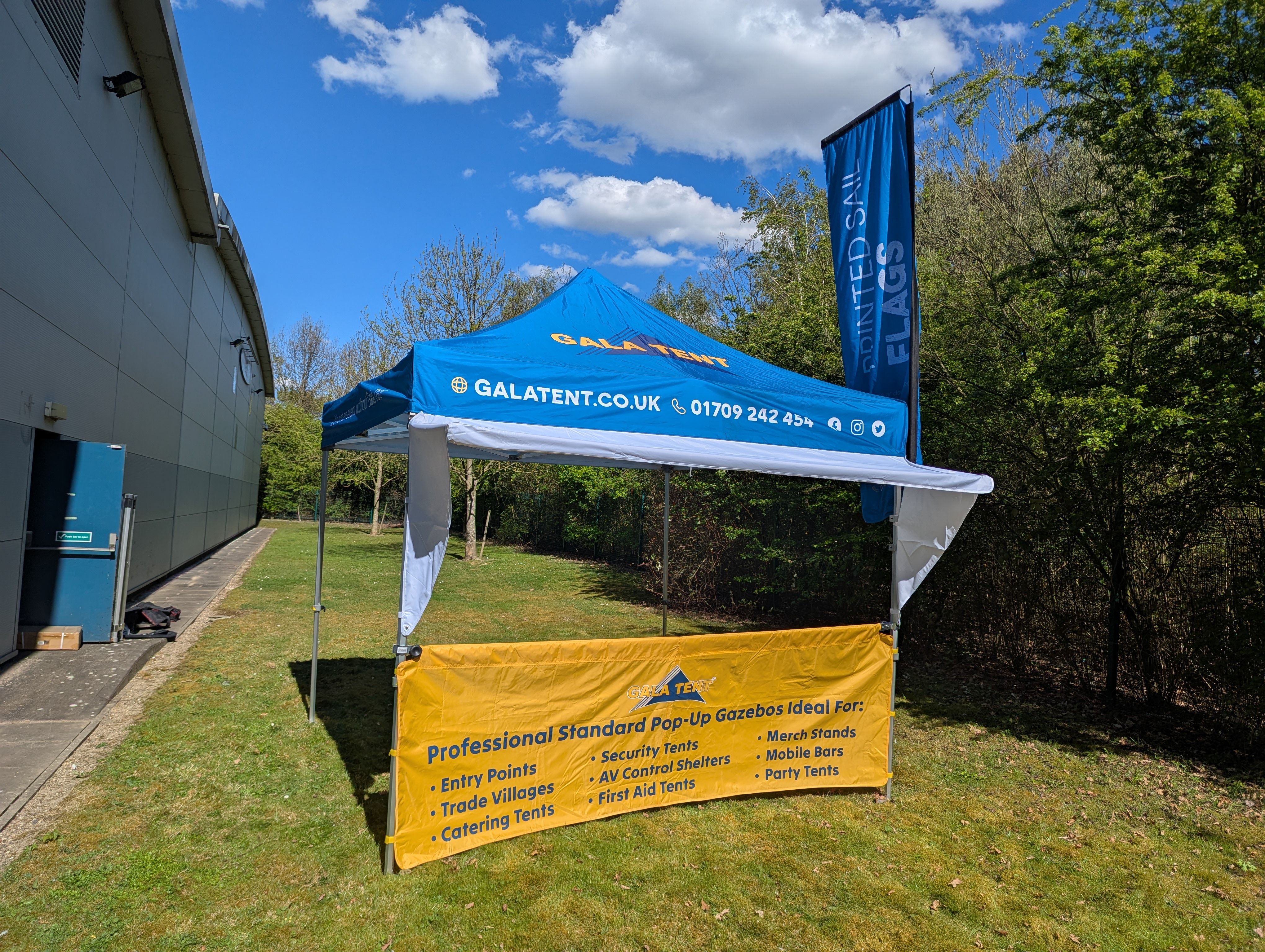 A yellow half wall on a blue pop up gazebo