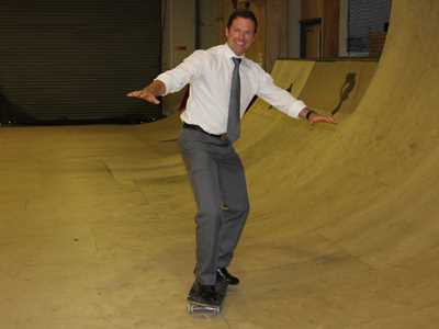 Gala Tent MD Jason Mace trying out skateboarding at Dexx Skatepark