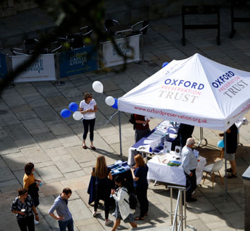 Branded gazebo with printed white canopy outdoors for Oxford Preservation Trust